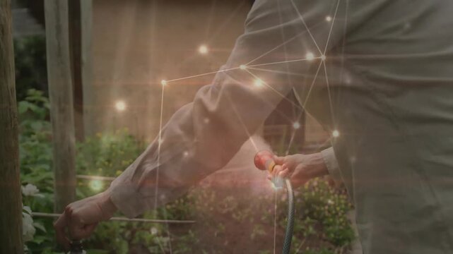 Woman gardener attaching hose and turning faucet valve starting animated water flow to water plants