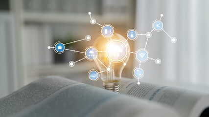 A light bulb symbolizes innovation with digital connections illustrated by various icons. Set against a book background, it conveys themes of knowledge and creativity in technology. Tessel © InfiniteFlow