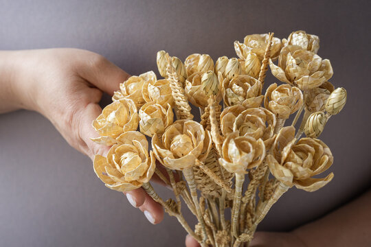 Wedding bouquet of flowers made of straw in female hands