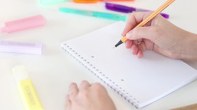 Hand drawing workflow diagram in notebook on white table