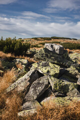Fototapeta premium Rock cairn marking hiking path in Carpathian mountain landscape under dramatic sky