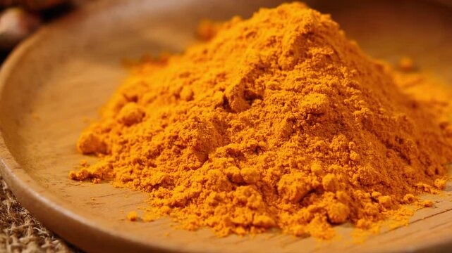 Turmeric powder in wood plate	