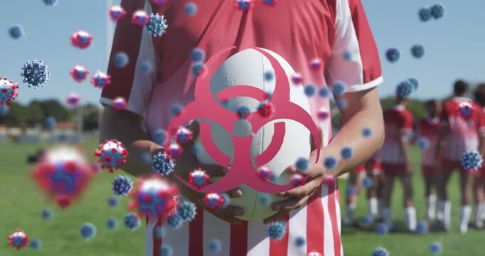 Animation of virus cells over diverse male rugby players with ball