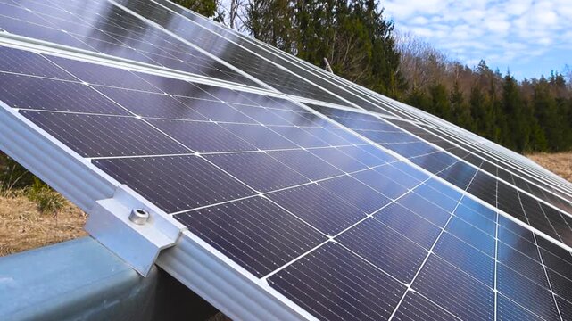 Solar panels reflecting the blue sky in a rural field
