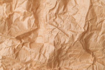 Obraz premium Texture of crumpled brown paper. Baking paper or vintage aged parchment, abstract background. Wallpaper for writing text and lettering. Backdrop for your design