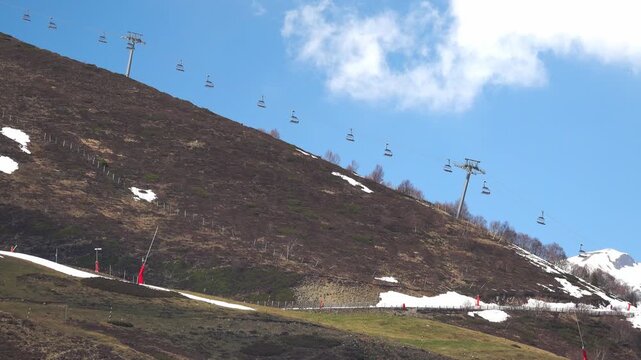Ski lifts move up the mountain on a clear day