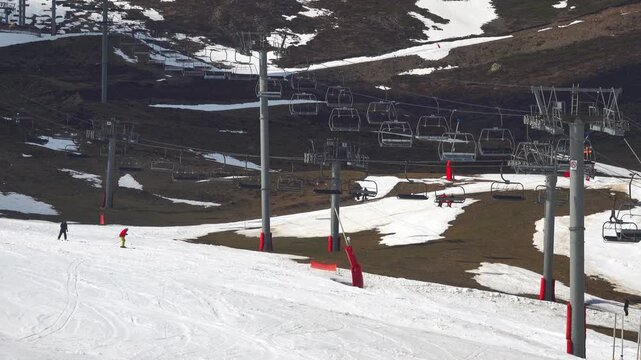 Skiers descend while lifts bring others up