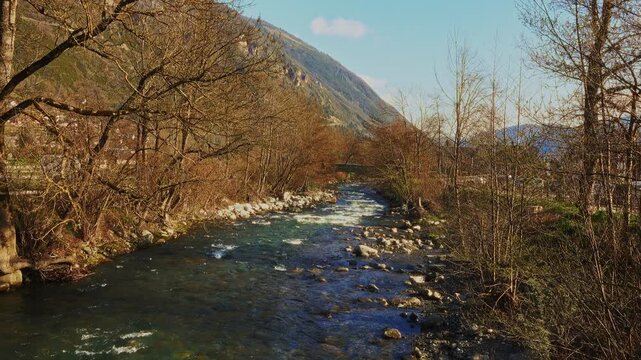 Spring water flows through riverbank rocks