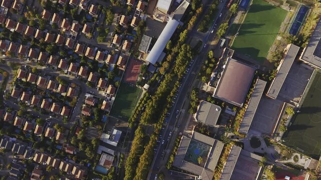 Top-down aerial tracking motion over the roads and residential borders of the university, San Carlos de Apoquindo, Las Condes, Chile, 4K.