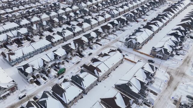 Rows Of Homes In A Housing Development Covered In Snow During Winter In Erin, Ontario. Orbiting Aerial Shot.