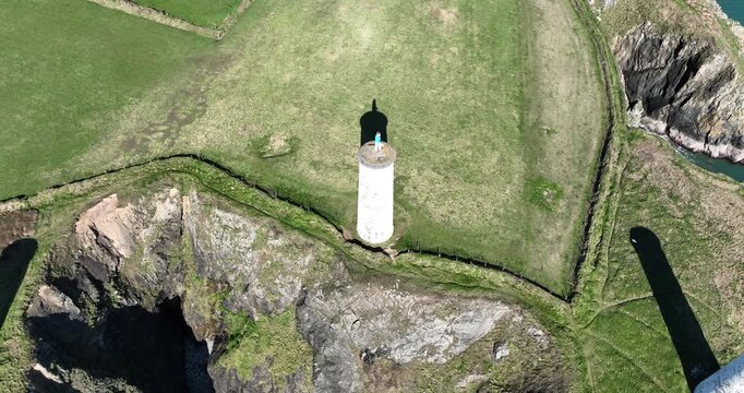 High drone circling The Metalman statue and pillar s warning ships of deadly coastline Tramore Waterford Ireland