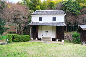 Traditional Japanese white-walled storehouse (Kura) surrounded by nature: Historical warehouse landscape © taka