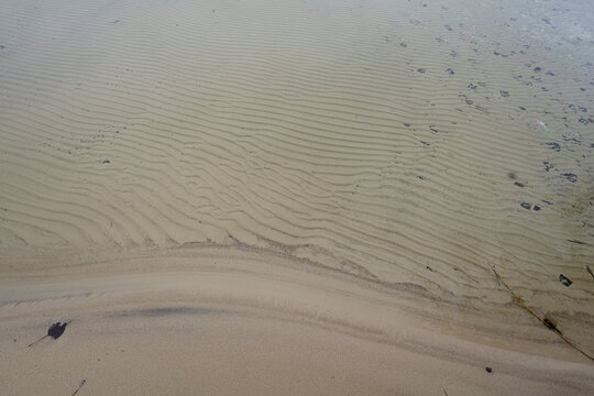 Sandy shore of the lake. Coastline of the lake. Close-up