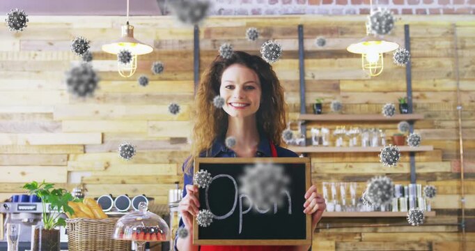 Animation of virus cells over happy caucasian waitress with open sign