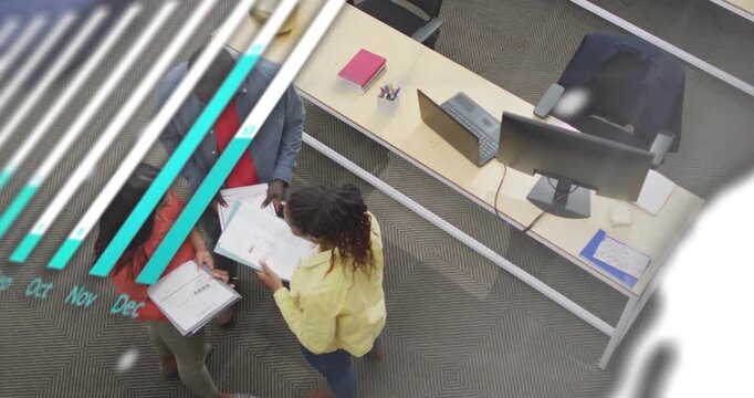 Animation of graphs, globe, computer language, overhead view of diverse coworkers discussing reports