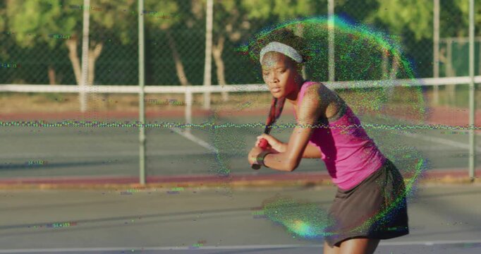Female tennis player preparing backhand as ball approaches and hitting return shot on sunlit court