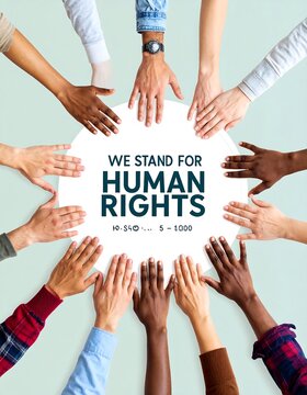 Diverse hands clasped in a circle, forming a unity symbol around the words "We Stand for Human Rights