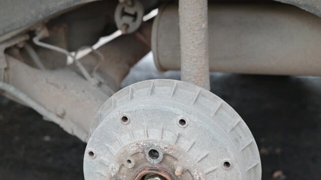 Detailed examination of a vehicle suspension system highlighting key components such as the wheel assembly and shock absorber