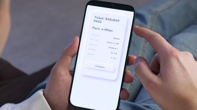 POV of a traveler using a mobile app to check a digital railway pass from Paris to Milan. Ideal for tourism ads, international travel vlogs, and modern transport promos. Highlighting the ease of