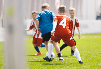 Youth Soccer Match Action. Kids Competing for Ball During Outdoor Football Game on Grass Field © matimix