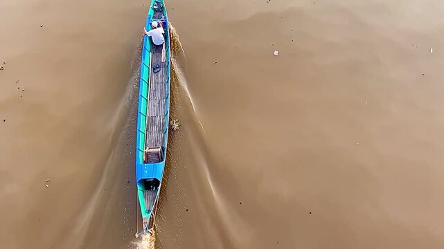 Top View of Long Boat Moving on Brown River Water with Minimalist Composition