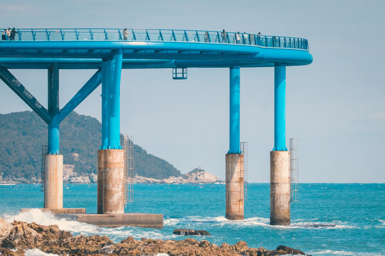 Cheongsapo Daritdol Skywalk in Haeundae Busan extending over blue sea with elevated structure. Scenic ocean view and popular tourism landmark with modern seaside architecture.