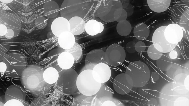 Bokeh light animation over black and white abstract background