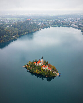 Aerial view of the iconic church on Bled Island reflecting in the serene lake, nestled in the heart of the Slovenian landscape, Bled, Radovljica, Slovenia.