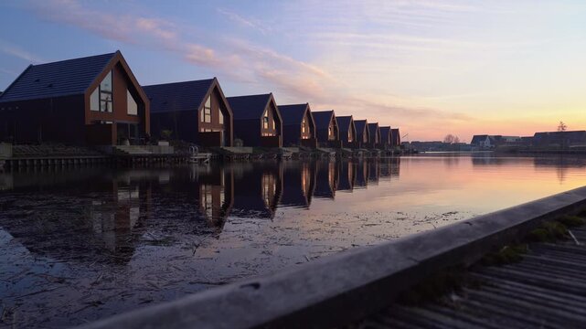 Sliding shot of a tranquil sunset in a suburb at the waterfront.