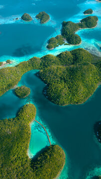 Aerial view of tropical islands with lush green vegetation and turquoise lagoons in Kangbangyo Island, Philippines.