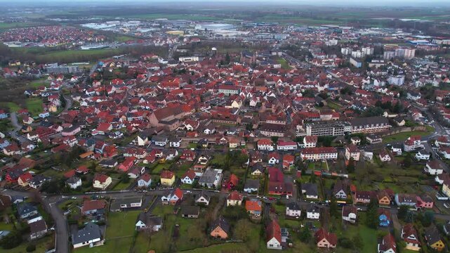 Aerial around the old town of the city Molsheim in France on a cloudy afternoon in later winter.