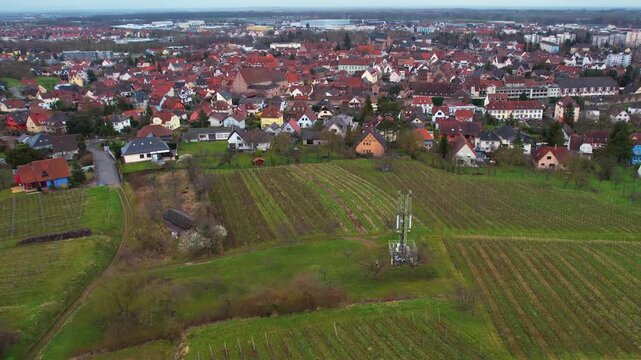 Aerial around the old town of the city Molsheim in France on a cloudy afternoon in later winter.