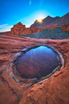 Redstone Dune Sunrise With Desert Tinaja Water Basin and Sunburst in Nevada
