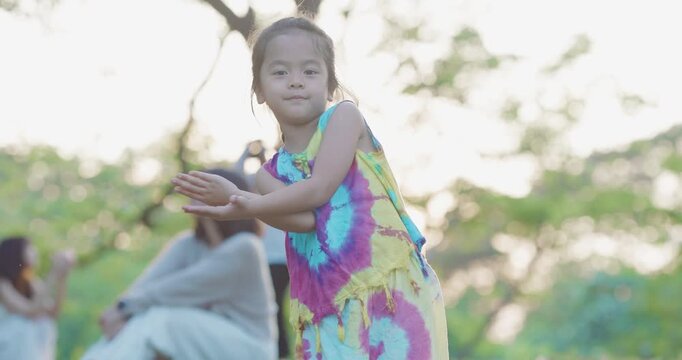 Adorable kids girl enjoy dancing outdoor city park sunset light