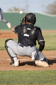 baseball catcher in position ready to catch a ball from the pitcher 