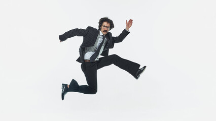 Obraz premium Businessman jumping with energetic pose isolated on white background studio shot. Concept of career growth, business success, goal achievement, positive momentum, high energy mindset