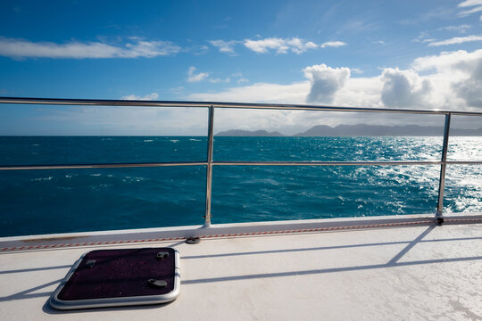 Views of the water and beaches on a catamaran sail boat on Sint Maarten island in the Caribbean Sea.