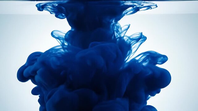 Ink diffusion in water creating beautiful patterns. Colorful liquid swirls through clear water. The mesmerizing motion captivates and inspires creativity.