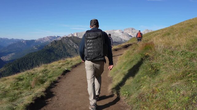 Tourists walk along the trail around the Langkofel mountain massif in the Dolomites.