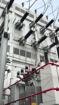 High voltage substation equipment and insulators at an electrical facility, showing power infrastructure for utility operations, preventive maintenance, safety checks, and grid reliability.