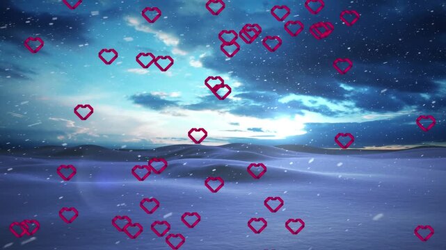 Animation of hearts and snow falling over winter landscape
