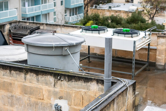 Rooftop Water Tank and Air Conditioning Units in Urban Malta, Residential Building Infrastructure