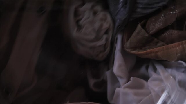 Gentle Drum Closeup Of Satin And Lace Spinning On Delicate Cycle Costume Designer Or Tailor Washing Delicate Vintage Pieces With Careful Handwash Technique, Soft Sheen And Slow Rotation