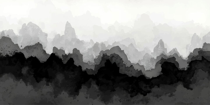 A serene morning panorama of the misty Alps peaks at sunrise, featuring a blue mountain landscape where fog and clouds drift over the forest valley and snowy silhouettes