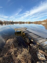 Fototapeta premium idyllic landscape with wooden pier over the beautiful lake