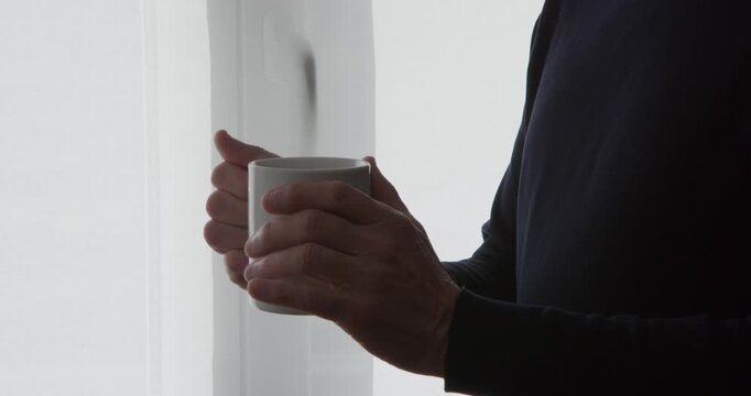 Morning Comfort: A person holds a warm cup of coffee in their hands, with steam gently rising, creating a scene of cozy solitude and peaceful contemplation.