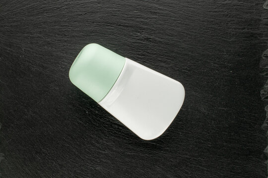 Antiperspirant isolated on slate stone, macro. Top view.