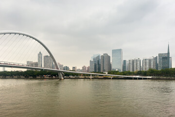 Fototapeta premium Zhujiang new town Guangzhou. Gray sky looms over urban riverbank