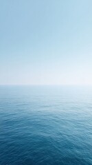 Obraz premium Minimalist ocean view, soft pale water and sky, misty horizon, large negative space.