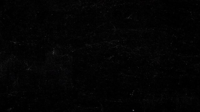 Dark grunge background animation featuring realistic chalk scratches, fine white veins, and subtle dust particles on black slate surface. Atmospheric texture for vintage title sequences, cinematic ove